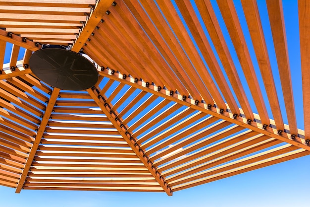 Wooden lattice roof of a beach umbrella Beach holidays by the sea