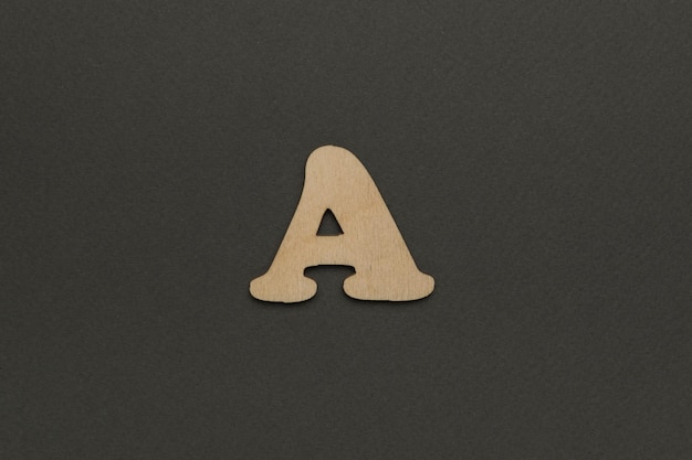 暗い灰色の背景の木製の文字A 英語のアルファベット