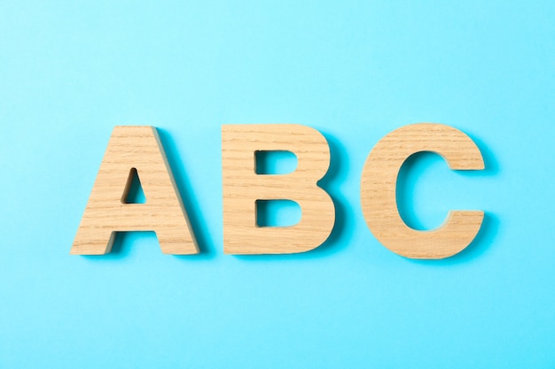 Wooden letters of English alphabet on blue background