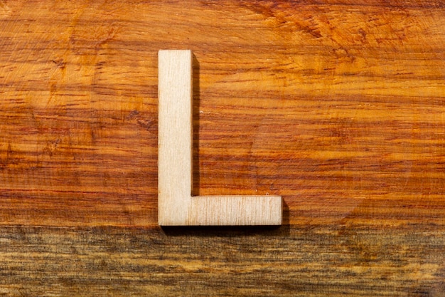 Wooden letters L on wooden background