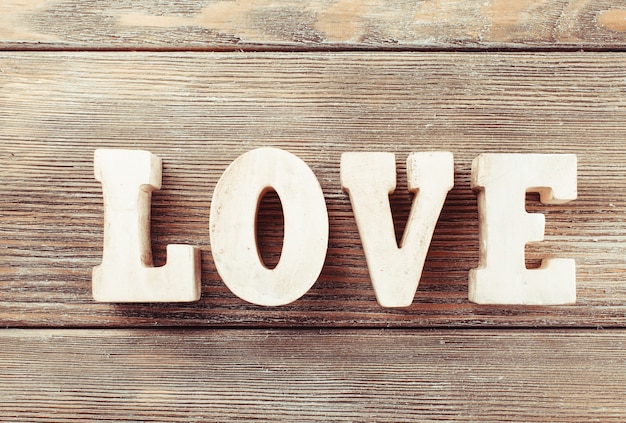 Wooden letters LOVE on a wooden background