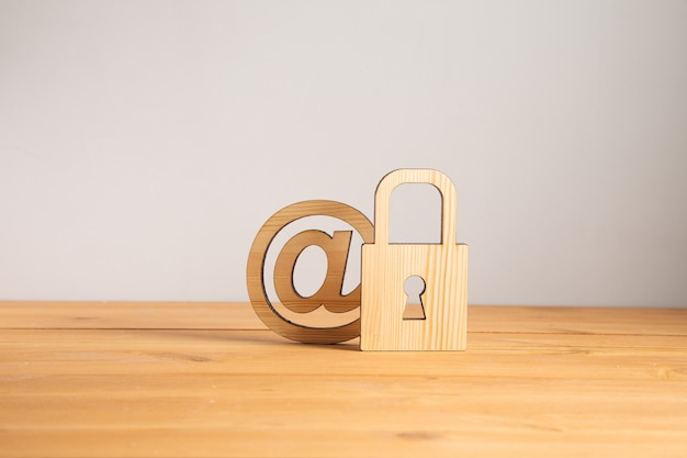 Wooden lock with mail sign on wooden background