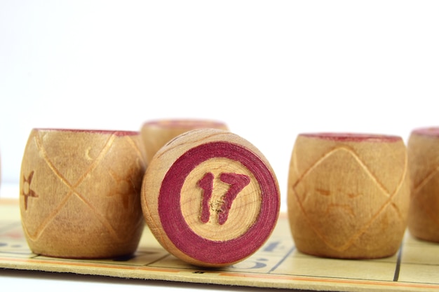 Wooden lotto barrels with number 17 isolated on a white background family bingo game