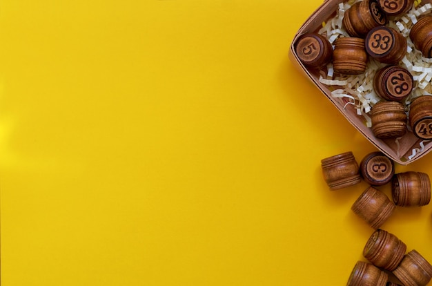 Wooden Lotto barrels on a yellow surface