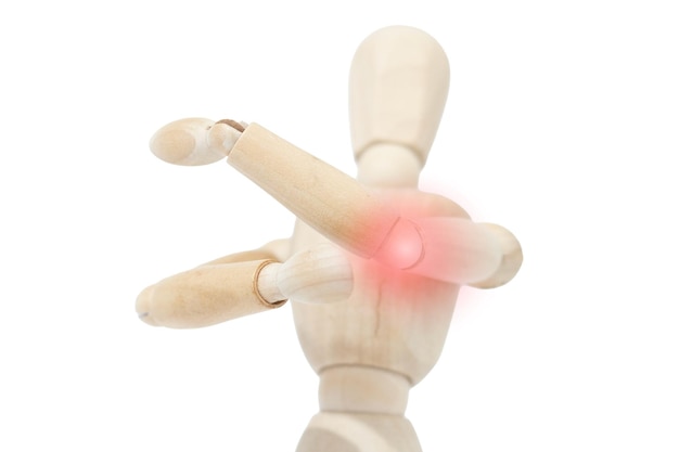 A wooden man suffering from elbow pain Joint pain Discomfort from ailment