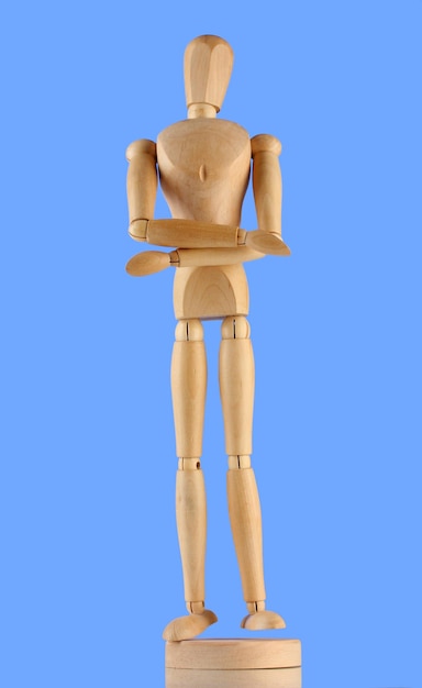 Wooden mannequin on blue background