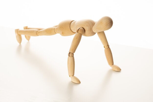 Wooden Mannequin Doing Push-Up Exercise