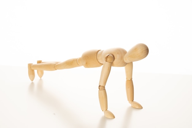 Wooden Mannequin Doing Push-Up Exercise