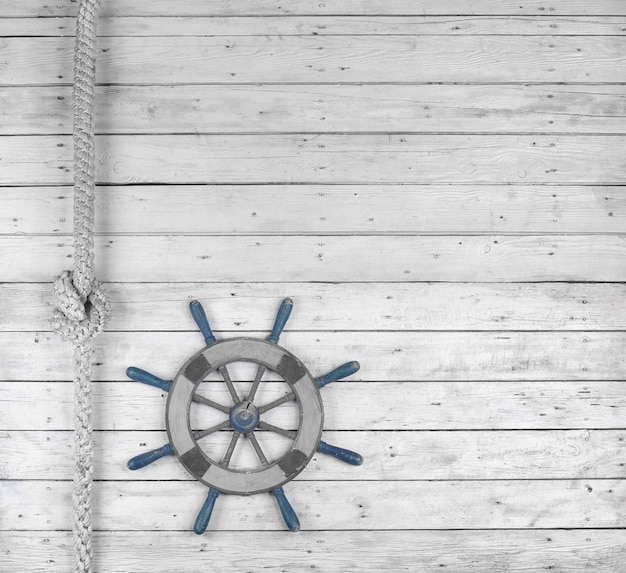 wooden marine steering wheel on white wooden background