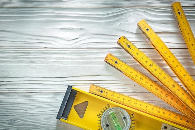 Photo wooden meter construction level on white board