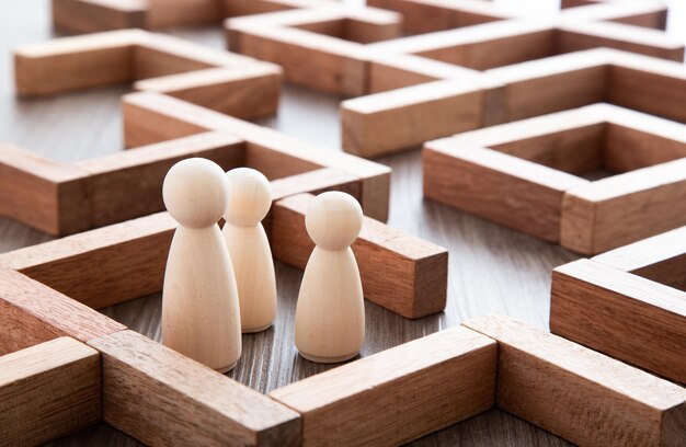 Wooden miniature at the start point of puzzle maze wood block\
leadership concept