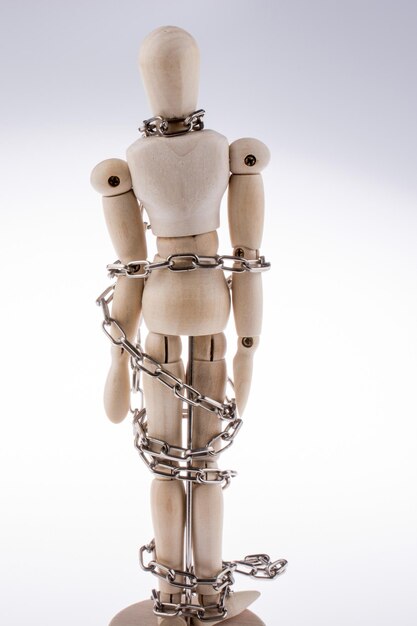 wooden model man in chains