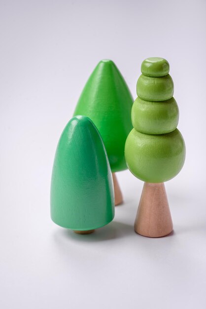 Wooden model of a tree with a green crown and trunk on a white background