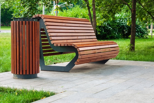 Wooden modern park bench and rubbish bin