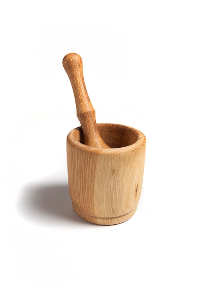 Wooden mortar with pestle isolated on a white background