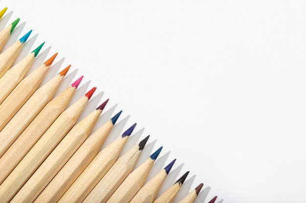 Wooden multicolored pencils isolated on white .Top view Copy space