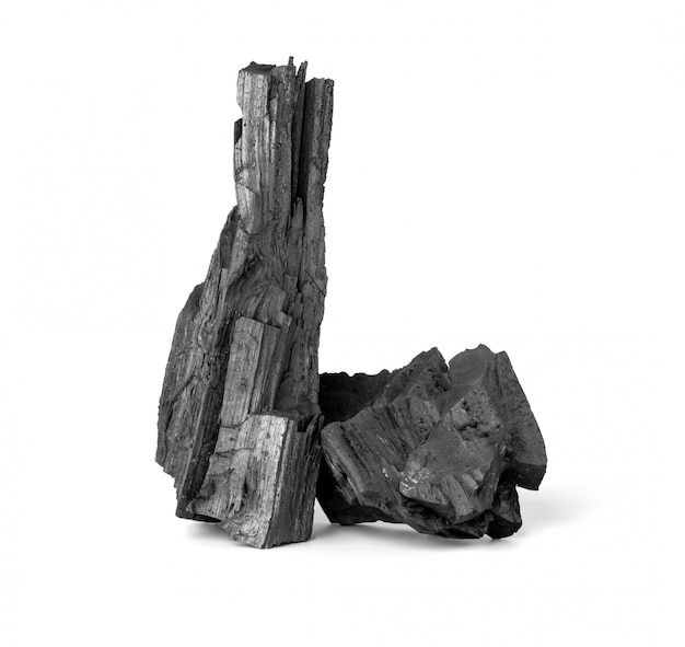 Wooden natural charcoal isolated on white surface