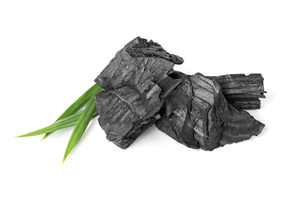 Wooden natural charcoal with pandan leaf isolated on white surface