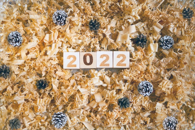 Wooden numbers cubes symbolizng christmas or new year celebration pine cones and shavings