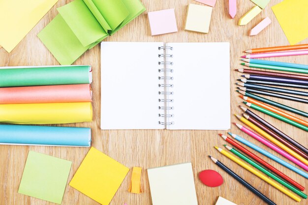 Wooden office table with colorful supplies