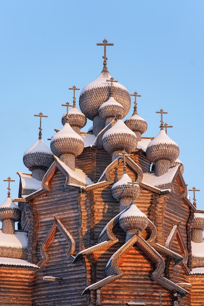 Wooden old Russian Orthodox church on blue sky