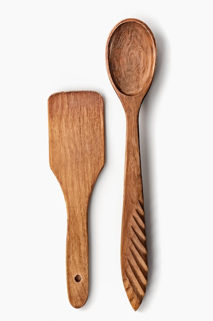 Wooden old spoon and wooden old spatula for the kitchen on a white background