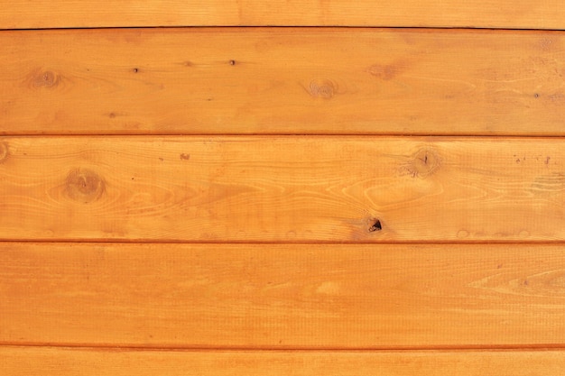 Wooden old wall made of boards lit by the sun full screen