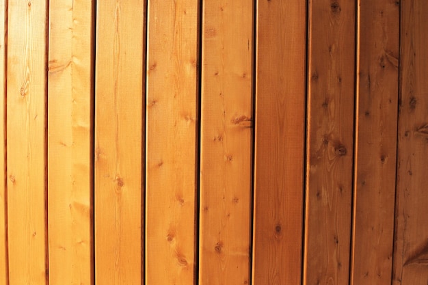 Wooden old wall made of boards lit by the sun full screen