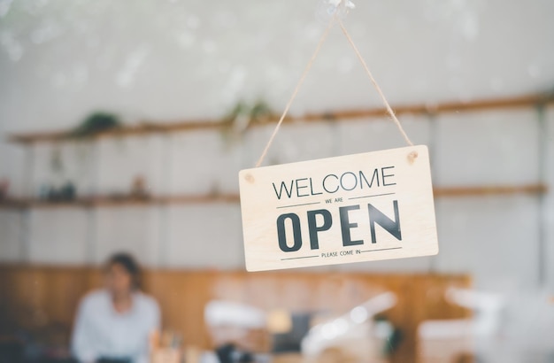 Wooden Open sign hangs at the cafe's or restaurant's entrance