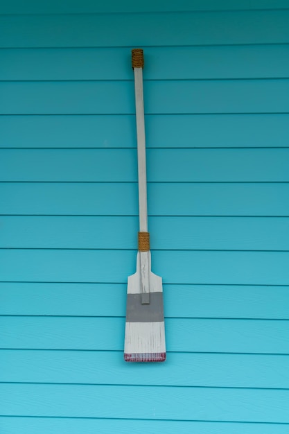 wooden paddle hanging on a wooden wall