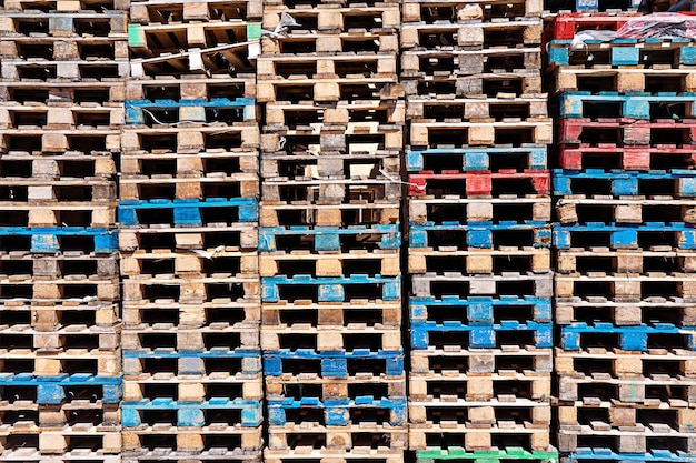Wooden pallets surface background, stack of pallet in warehouse