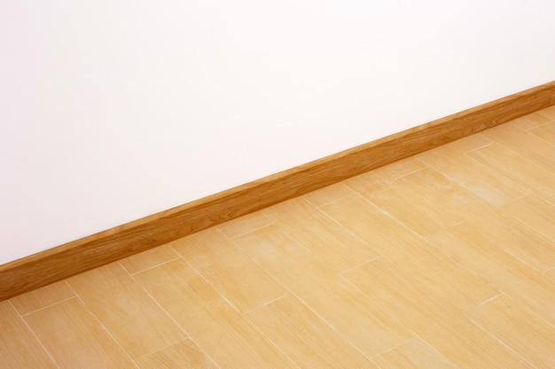 Wooden pattern tiles floor with blank white wall