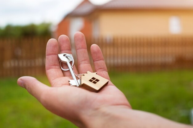 Wooden pendant of a house and key