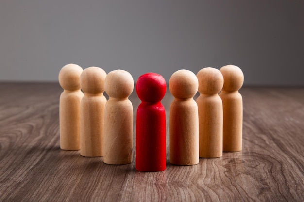 Wooden people figures on top of wooden blocks career growth
development and leadership