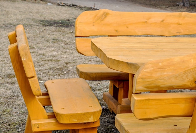 Wooden picnic table with benches on a grass lawn