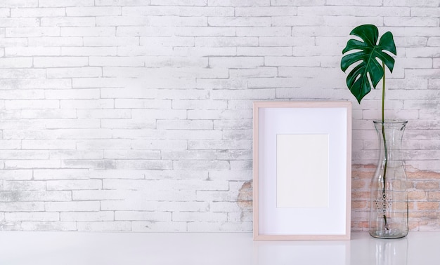 wooden picture frame and glass vase of plant