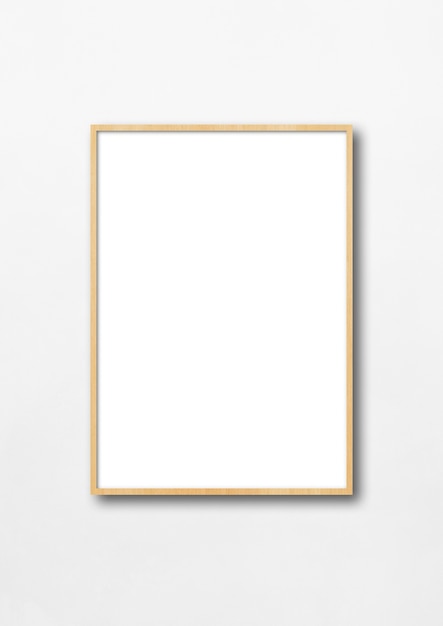 Wooden picture frame hanging on a white wall.