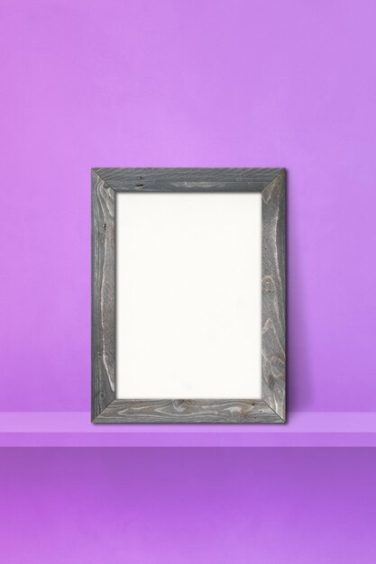 Wooden picture frame leaning on a purple shelf. 3d illustration. Blank mockup template. Vertical background