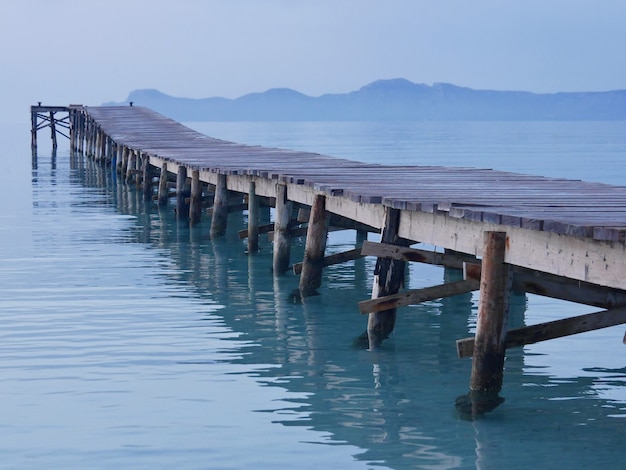 Wooden pier beautiful sunrise Alcudia beach Mallorca Spain