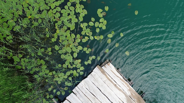 Wooden pier on lake water aerial view