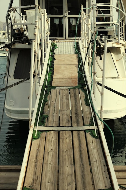 Wooden pier leading in ship at harbor