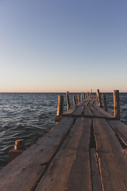 Wooden pier at seaside Aerial seascape on ukrainian island Dzharylgach Summer vacations