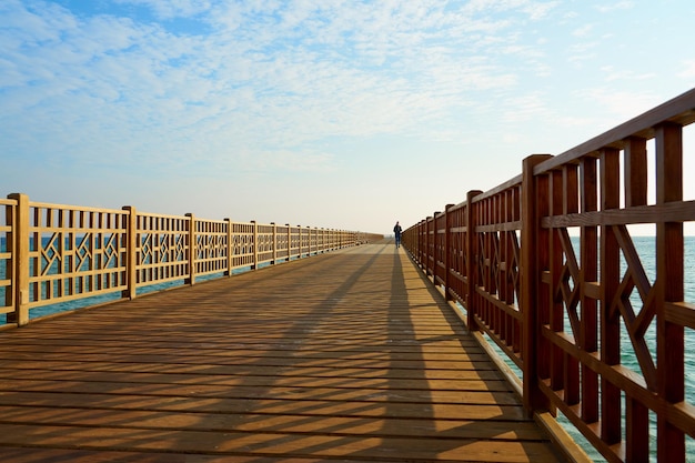 A wooden pier on the shores of the Red Sea with a horizon in the background