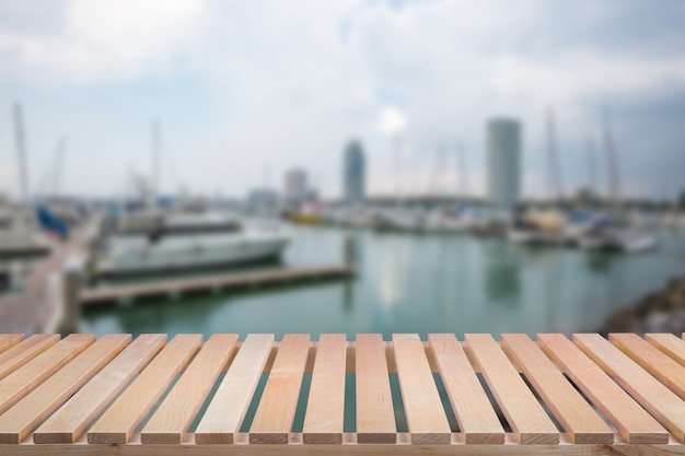 Wooden pier with yacht background