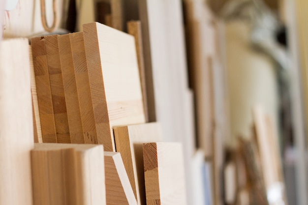 Wooden pillars and thick boards in the furniture workshop are ready to work joiner