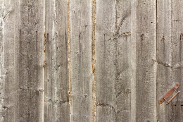 Wooden plank fence made of rough rough boards