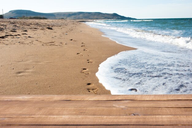 Wooden planks on the background of the sea beach