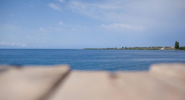 Wooden planks on the pier above the blue sea top of the water