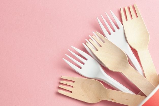 Wooden and plastic forks at paper and plastic cup