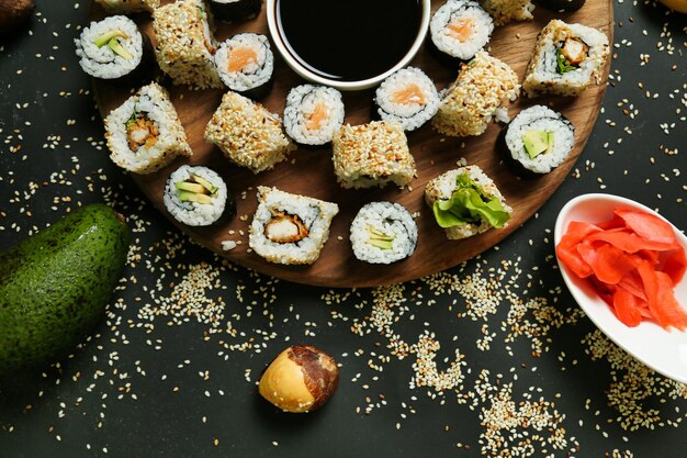 Wooden Plate of Sushi With Dipping Sauce